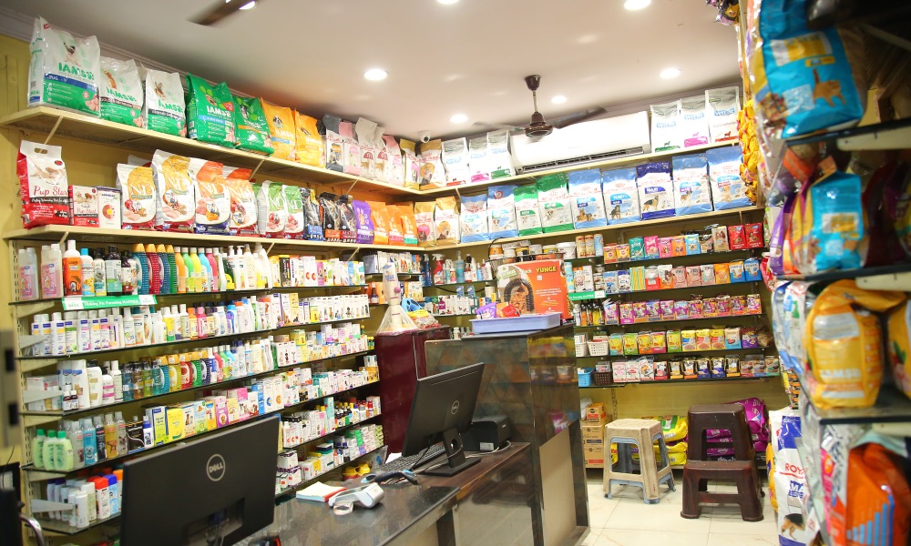 Inside the store: the billing counter surrounded by shelves of pet medicines and supplies.